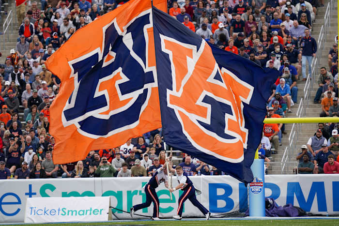 Dec 28, 2021; Birmingham, Alabama, USA; Auburn Tigers cheerleaders let the flags wave after a score against Houston Cougars during the second half of the 2021 Birmingham Bowl at Protective Stadium. Mandatory Credit: Marvin Gentry-USA TODAY Sports